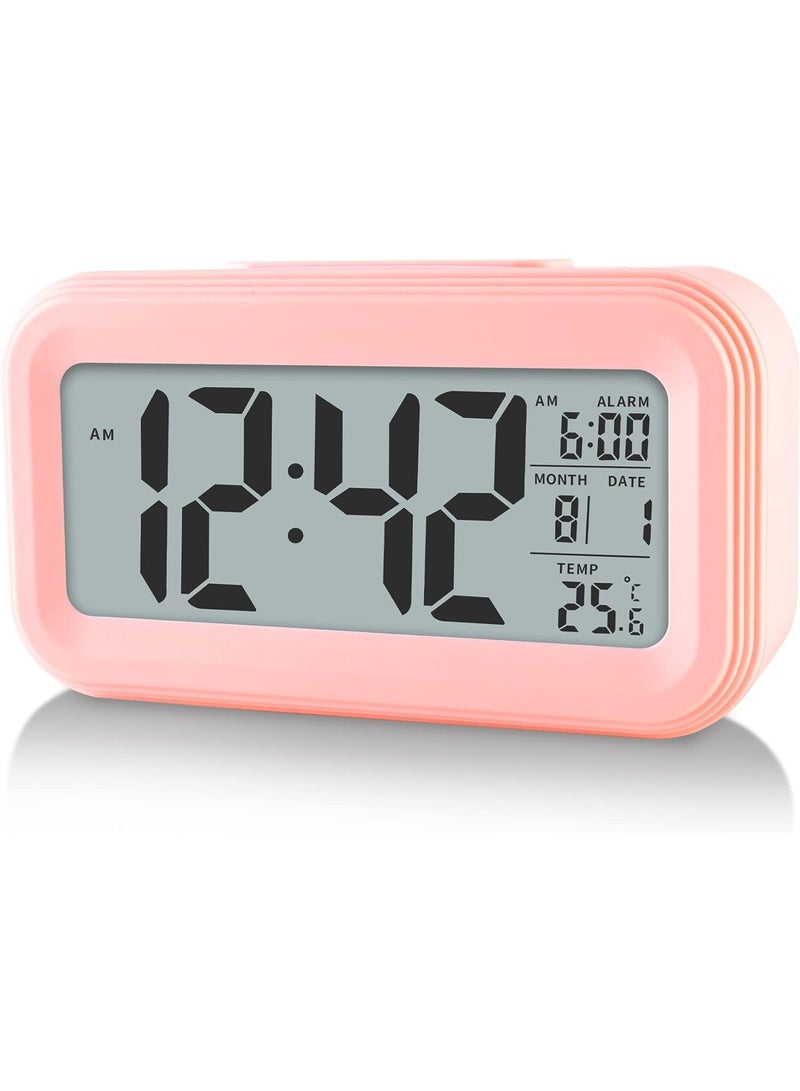A small pink LCD electronic clock that displays the time, date, indoor temperature (-9.9 to 50 degrees Celsius), alarm with a 5-minute "snooze", supports 12/24 hours, ideal for the office, bedroom or kitchen with a stylish and simple design. - Image 1